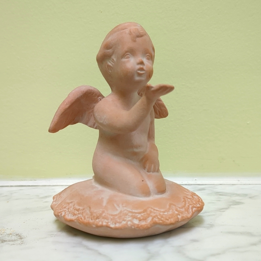 Cherub angel blowing a kiss